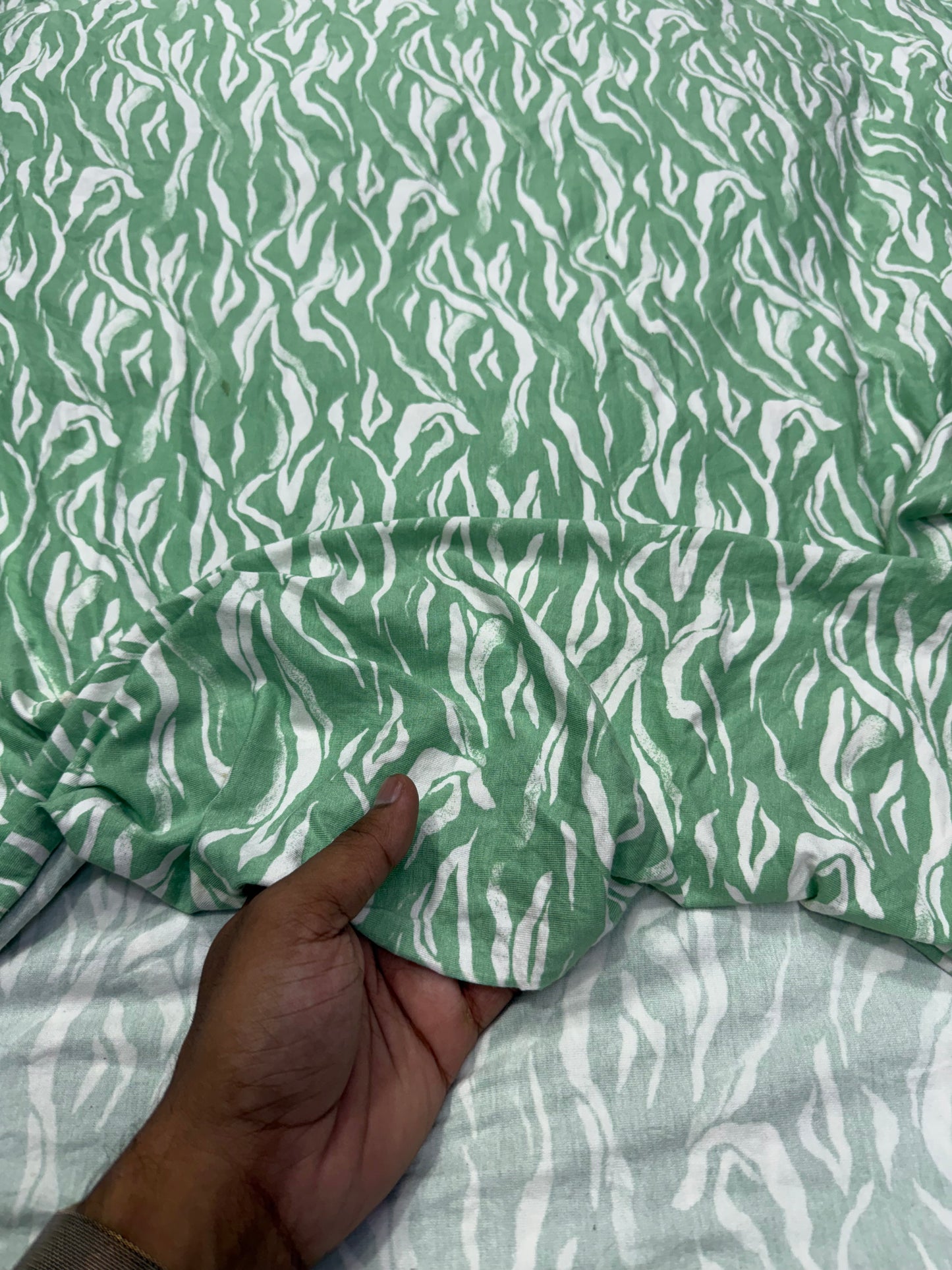 Buy Knitted Stretchable Green Base White Leafy Printed Fabric